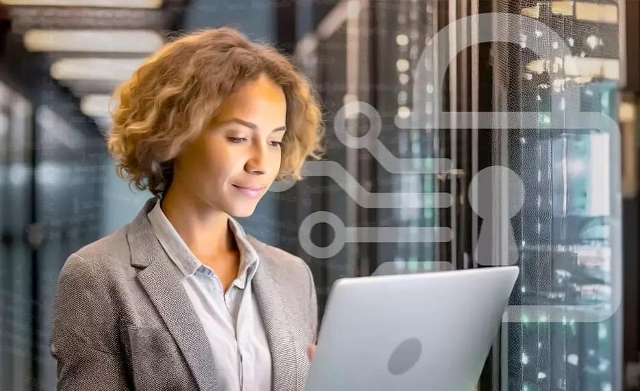 Businesswoman standing working on computer