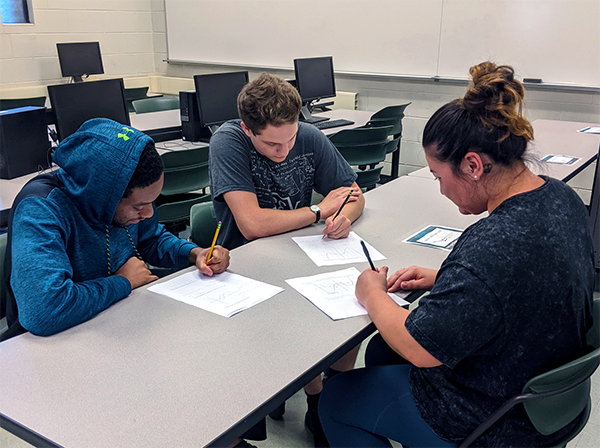 JU math students working together on a math problem.