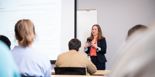 A female teacher instructing multiple students in health sciences