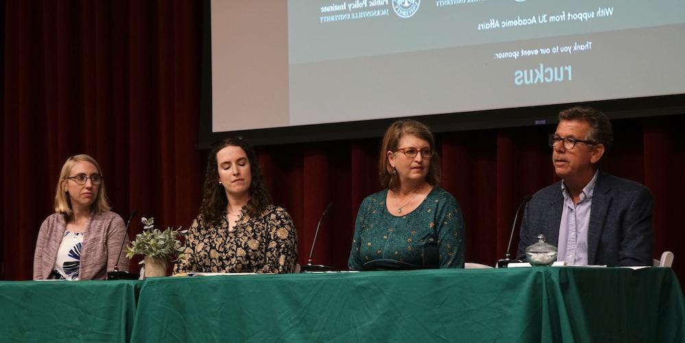 Four experts sitting at a panel 